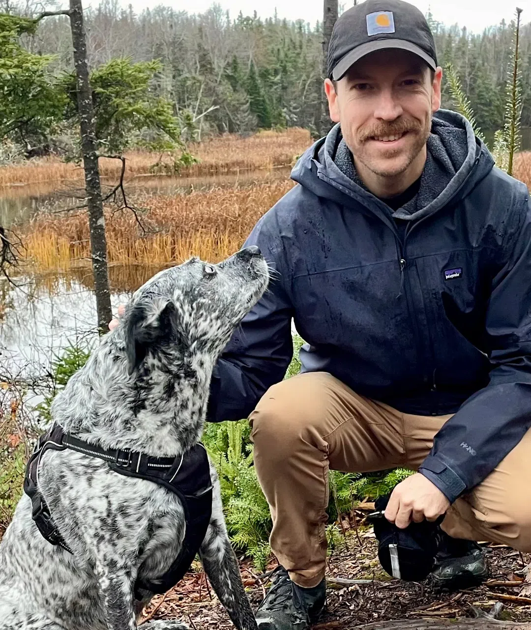 Crouched beside Gordie on a woodland trail